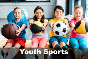 Four children holding different sports balls